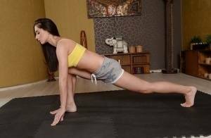 Cute brunette babe Aruna Aghora doing yoga in shorts and bare feet on myfans.pics