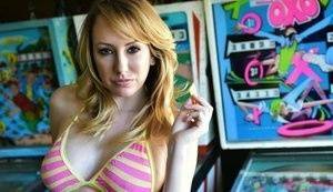 Brett Rossi fingers her pussy in striped OTK socks atop pinball machine on myfans.pics