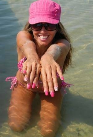 Amateur model Lori Anderson shows her hairy arms while wearing a bikini on myfans.pics