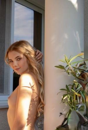 Young blonde Chanel Fenn shows her sexy ass while getting naked in a garden on myfans.pics