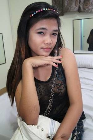 Young Filipina girl with a saucy look stands naked after undressing on myfans.pics